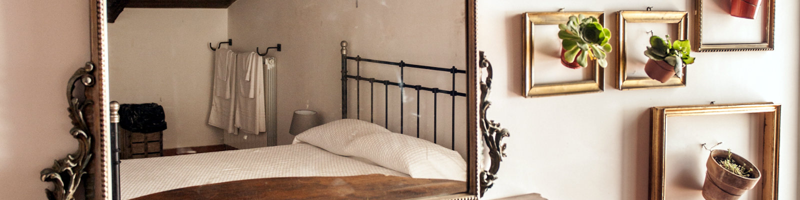 The Church B&B bedroom with ornate mirror and succulents